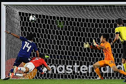 Chile?s Sanchez (in red) scores against Japan in Copa America