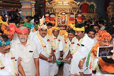 Puducherry CM and other Congress party members pull the golden car of the Manakkula Vinayagar Temple
