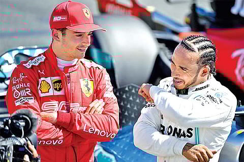 Lewis Hamilton (right) interacts with Ferrari driver Charles Leclerc, who will start third in the grid