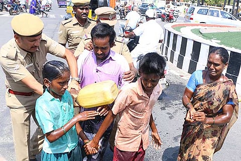 Police take away the family members who attempted suicide at the Salem collectorate on Monday