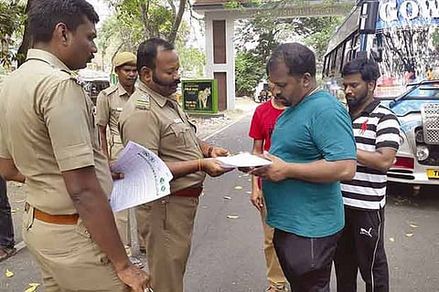 Officials distribute leaflets to tourists in Aliyar near Pollachi