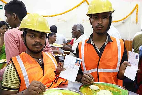 Construction workers have free food at Amma Canteen in Santhome after showing their identity cards