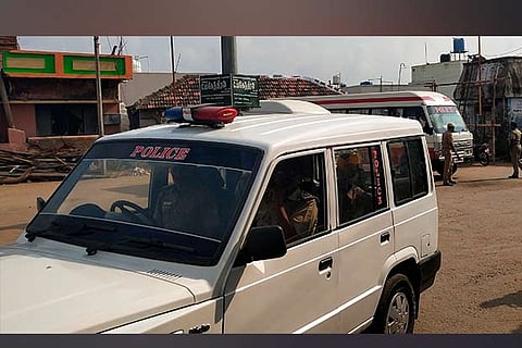 A police car patrols the locality near Anaimalai on Monday following the group clash