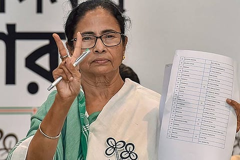 West Bengal CM, TMC Chief Mamata Banerjee shows the candidates' list for upcoming Lok Sabha election