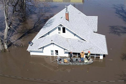 Lanni Bailey and a team from Muddy Paws Second Chance Rescue enter a flooded house