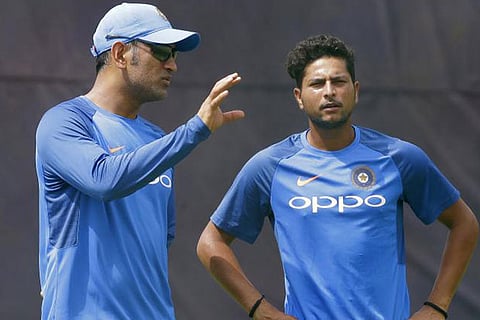 MS Dhoni (left) and Kuldeep Yadav