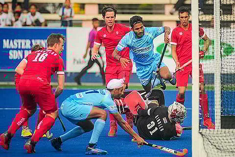 Indian hockey player Mandeep Singh shoots a goal in India's 7-3 win against Canada