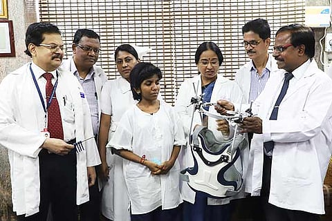 The patient with the team of doctors at RRGH