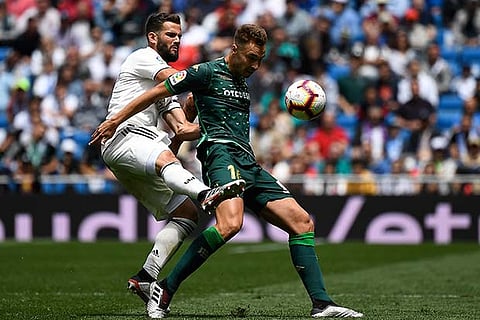 Real?s Nacho Fernandez (left) challenges Betis forward Loren Moron