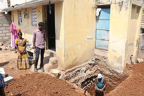 Software engineer Dinesh Saravanan and beneficiary Latha supervising the construction of the toilet