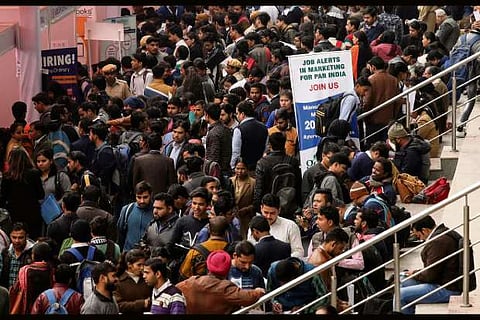 Job seekers attend a job fair - Source: Reuters