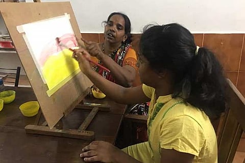 Melvena Michael engrossed in a painting session