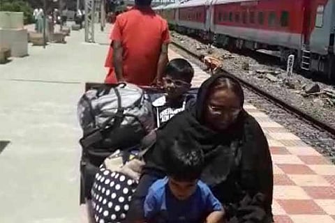 A senior citizen along with her grandchildren forced to travel on a luggage trolley to reach the exit gate