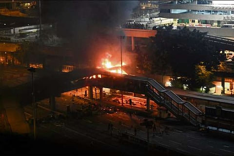 Protesters set fire to hold off police at Hong Kong campus