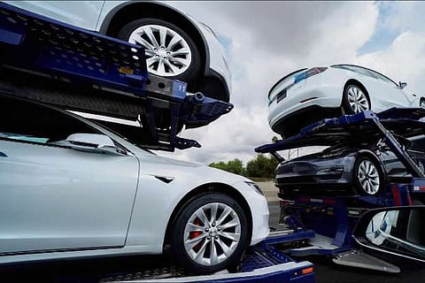 Tesla vehicles are shown on a delivery truck in Los Angeles, California
