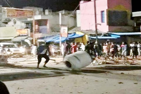 A fan of the actor damaging a barrel at Krishnagiri on Friday
