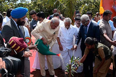 Governor Banwarilal Purohit waters a sapling planted at TNAU