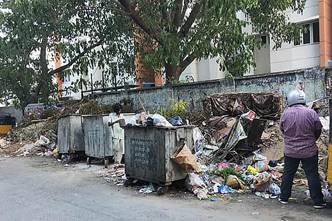 The garbage overflowing from bins