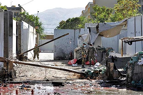 Afghan police inspect the site of a suicide attack, in Parwan province of Afghanistan