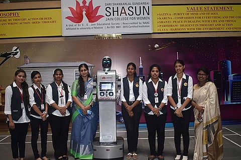 Sara, the humanoid robot (centre), along with its student architects and their mentors
