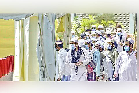 People, who attended the Nizamuddin event, walk to board a bus for the LNJP Hospital