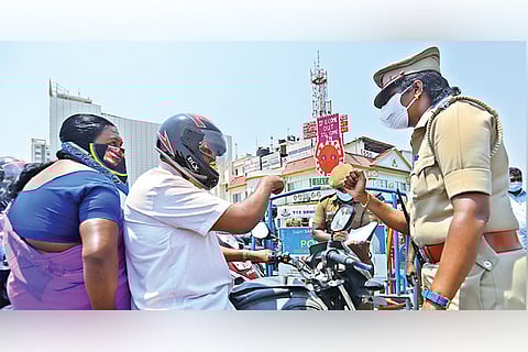 Police personnel check vehicles due to the ongoing lockdown