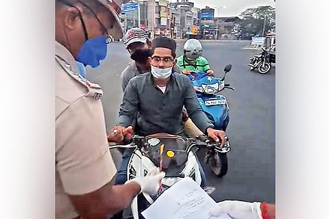 Cops apply yellow tilak on a two-wheeler in Triplicane