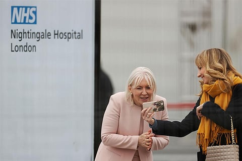 Nadine Dorries, MP looks at a phone during the opening of the NHS Nightingale Hospital (Reuters)