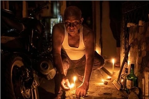 A man lights candles in New Delhi | Reuters