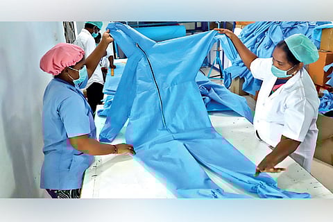 Workers preparing protective gear at a unit in city