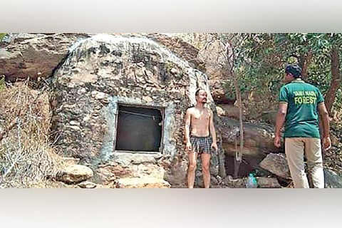 The man from China standing in front of the cave on Annamalai Hills