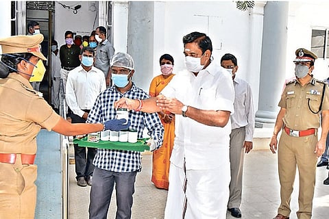 Palaniswami distributes packets of the Siddha drink