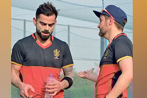 RCB captain Virat Kohli (left) interacts with team director Mike Hesson