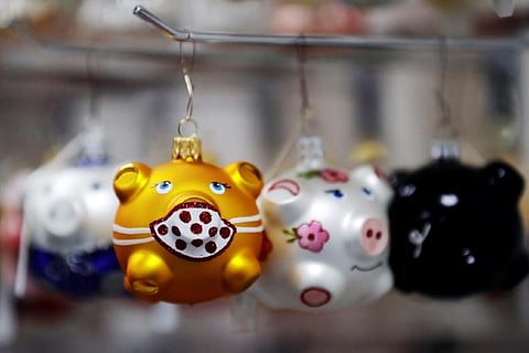 Czech golden pig ornaments get mask for COVID Christmas