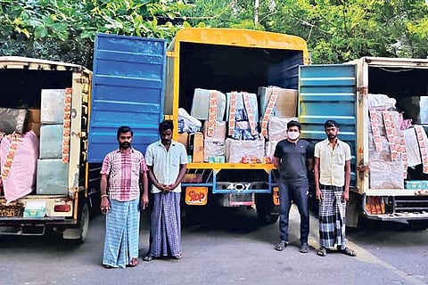 The seized trucks along with the owner of the vehicles and the three drivers.