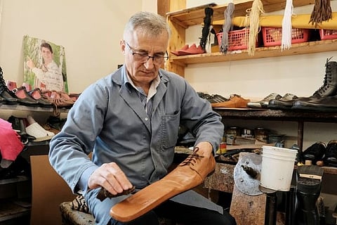 Romanian cobbler makes size-75 winter boots to stamp out COVID-19