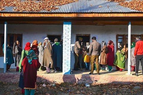 Voters stand in queues at Gund Khawaja Qasim area of Pattan in Baramulla District of North Kashmir
