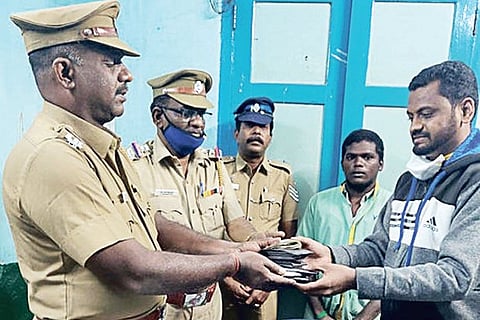 Railway police handing over the bag to Niyaz Ahamed, the owner, in Kumbakonam