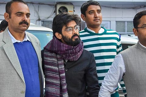 Sharjeel Imam (centre) taken by police