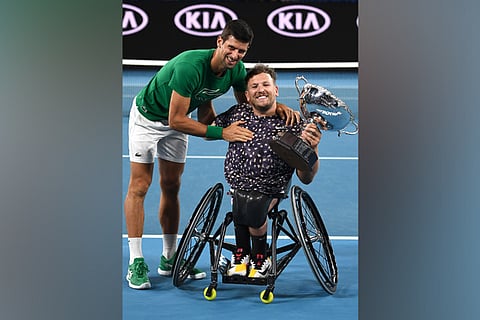 Novak Djokovic (left) greets Dylan Alcott on his victory in the men?s quad wheelchair singles final