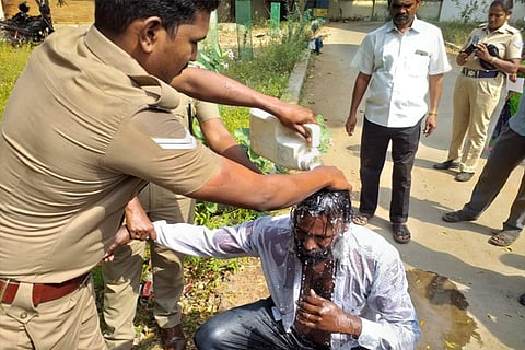 Manikanan being rescued by police in Tiruchy on Monday