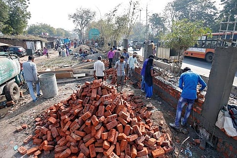 A wall being built along a slum area in Ahmedabad ahead of President Trump visit