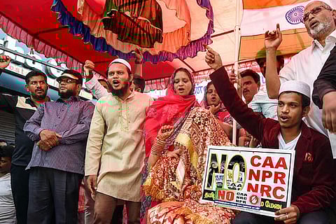 A newly-wed couple along with others raises slogans during an anti-CAA rally, at Washermenpet in Chennai