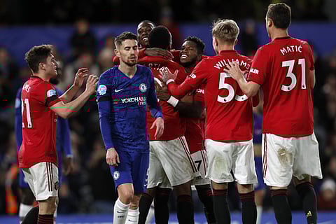 Manchester United players celebrate their win over Chelsea in the Premier League