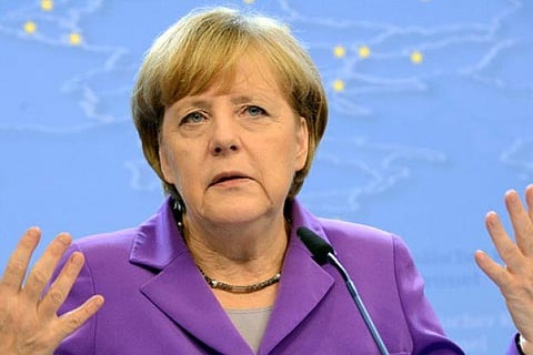 Merkel slams 'poison' of racism after nine killed in Germany shootings