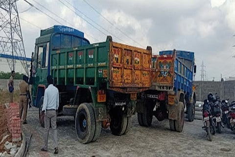 The lorries were half-filled with sand and they were using the earthmovers to mine the sand