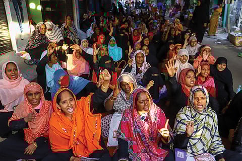 Women shout slogans as they stage a sit-in at the venue of CAA protest at Washermenpet in city on Tuesday