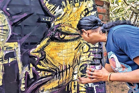 One of the volunteers painting banners
