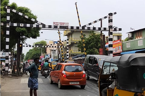 The railway level crossing is closed over a dozen times in a day to allow petroleum containers to pass through