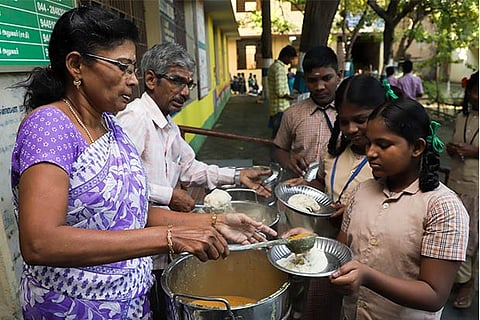 Students enjoying morning meal at the Government Higher Secondary School at Kamaraj Avenue, Adyar